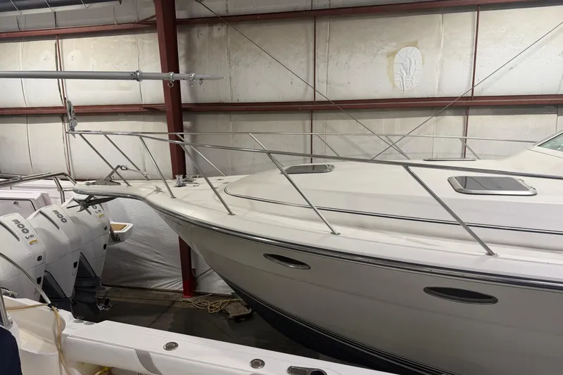 Slide: The Image of 1989 Tiara Yachts 3600 Open in storage, showcasing sleek design and dual engines. - 3
