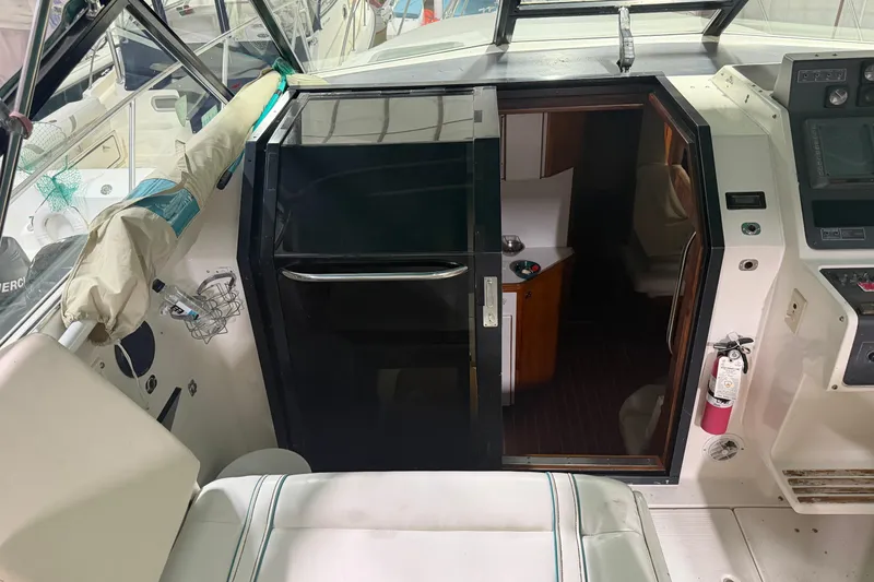 Slide: The Image of 1989 Tiara Yachts 3600 Open cabin entrance with cockpit view and fire extinguisher. - 30