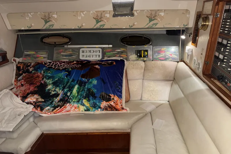 Slide: The Image of 1989 Tiara Yachts 3600 Open interior with cozy seating and fishing gear storage. - 34