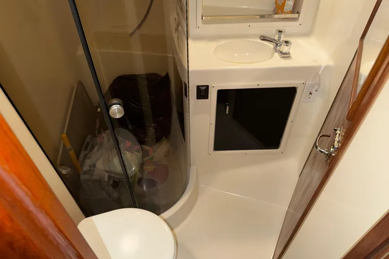 Slide: The Image of Bathroom interior of 1989 Tiara Yachts 3600 Open, featuring shower and sink. - 39