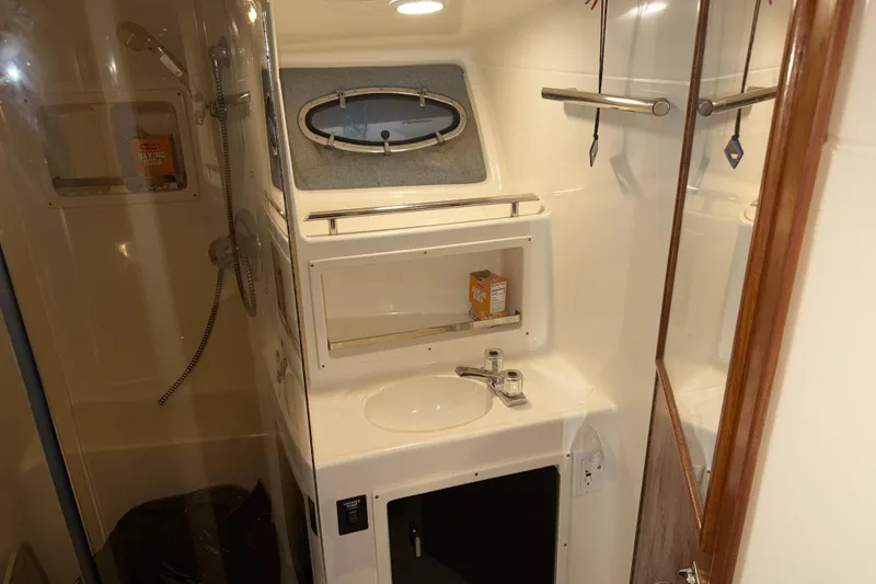 Slide: The Image of 1989 Tiara Yachts 3600 Open bathroom with sink, mirror, and shower area. - 40