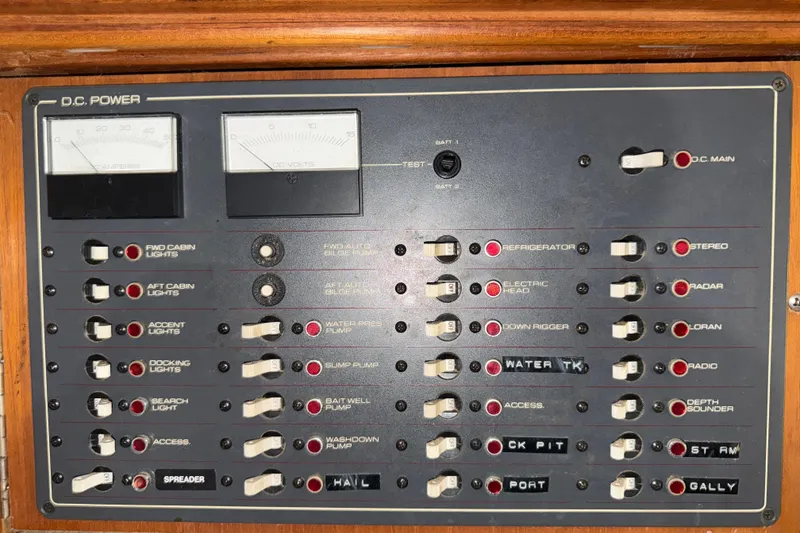 Slide: The Image of 1989 Tiara Yachts 3600 Open DC power control panel with switches and gauges. - 45