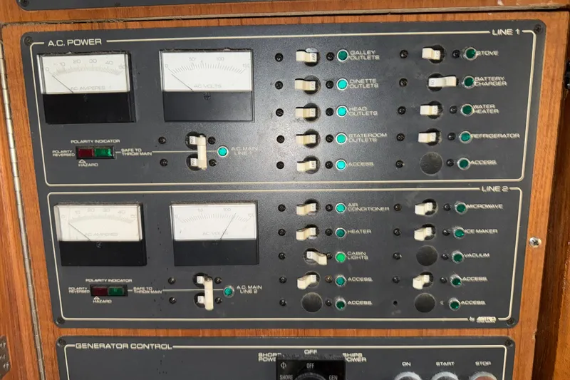 Slide: The Image of Control panel of a 1989 Tiara Yachts 3600 Open, featuring AC power and generator controls. - 46