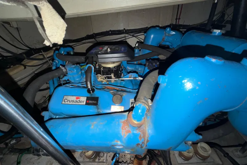 Slide: The Image of Engine compartment of a 1989 Tiara Yachts 3600 Open, featuring a blue Crusader engine. - 49