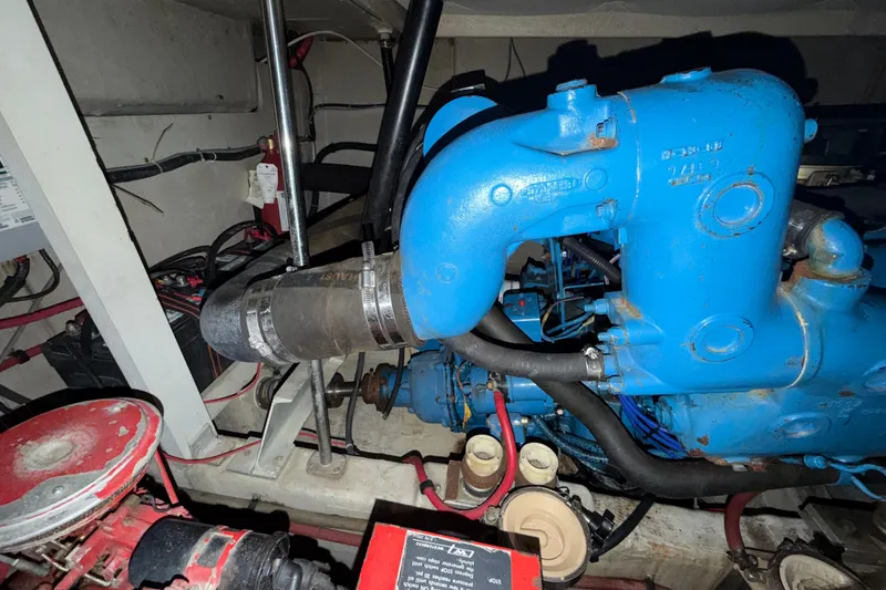 Slide: The Image of Engine room of a 1989 Tiara Yachts 3600 Open, featuring blue engine components. - 53