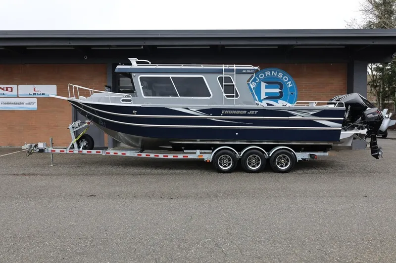 The Image of 2026 Thunder Jet 28 Pilot boat on trailer, parked outside a building. - 1