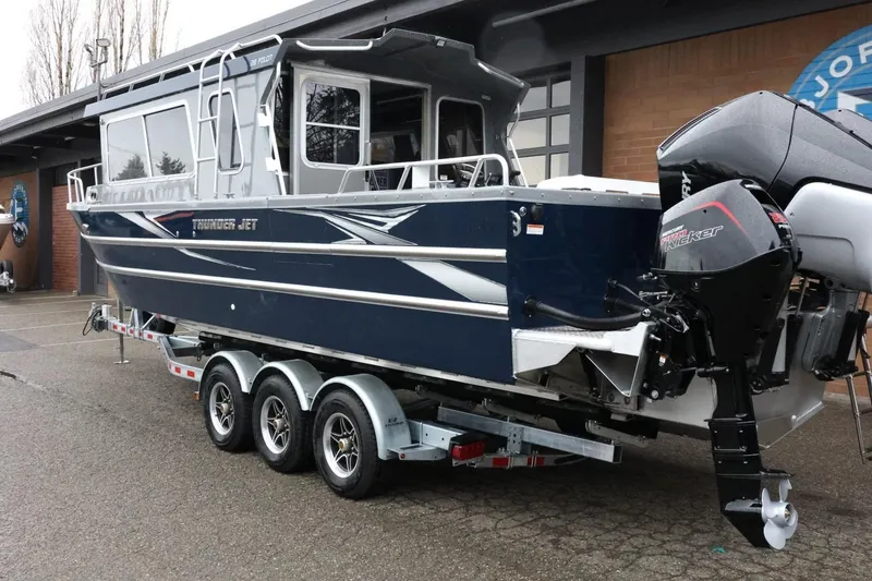 Slide: The Image of 2026 Thunder Jet 28 Pilot boat on trailer, featuring powerful outboard motors. - 11