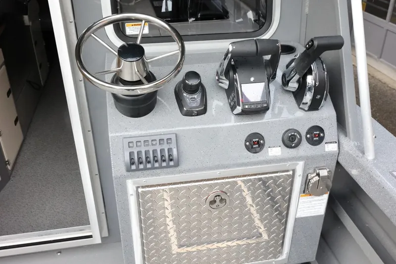 Slide: The Image of Control panel of 2026 Thunder Jet 28 Pilot boat with steering wheel and throttle controls. - 14