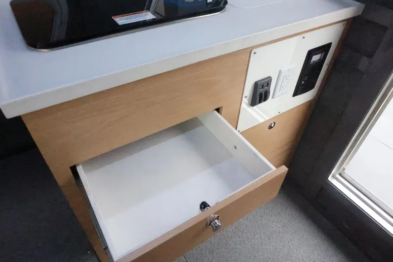 Slide: The Image of Open drawer and electrical outlets in 2026 Thunder Jet 28 Pilot boat interior. - 42
