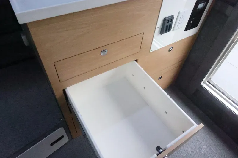Slide: The Image of Open drawer in Thunder Jet 28 Pilot 2026 boat interior, showcasing storage space. - 43