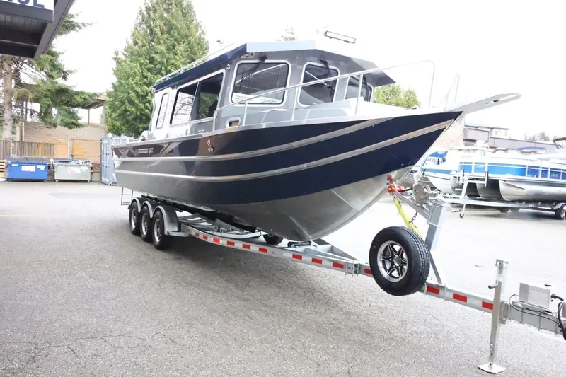 Slide: The Image of 2026 Thunder Jet 28 Pilot boat on a trailer, parked outdoors. - 5