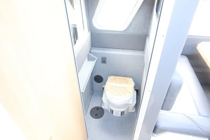 Slide: The Image of Interior of 2026 Thunder Jet 28 Pilot boat featuring compact toilet area. - 54