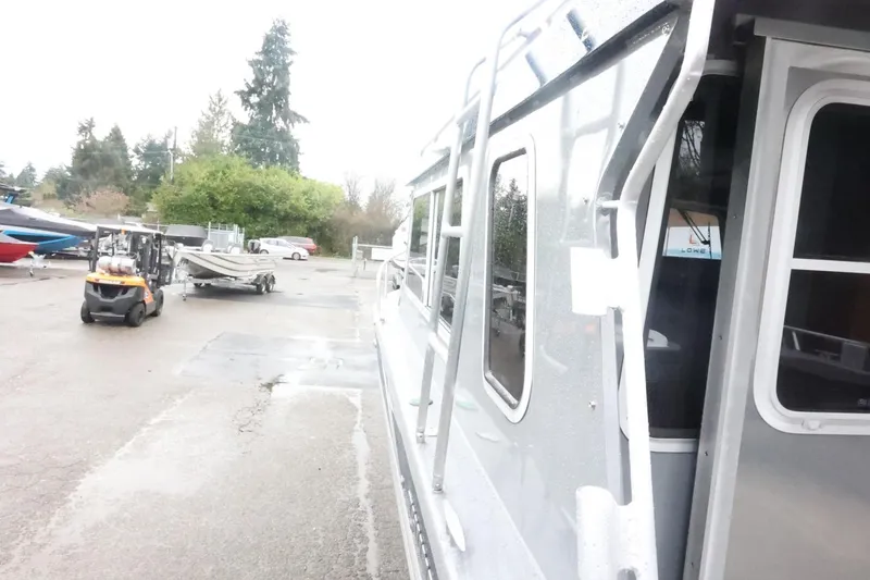 Slide: The Image of 2026 Thunder Jet 28 Pilot boat in a marina with forklift and trailer nearby. - 61