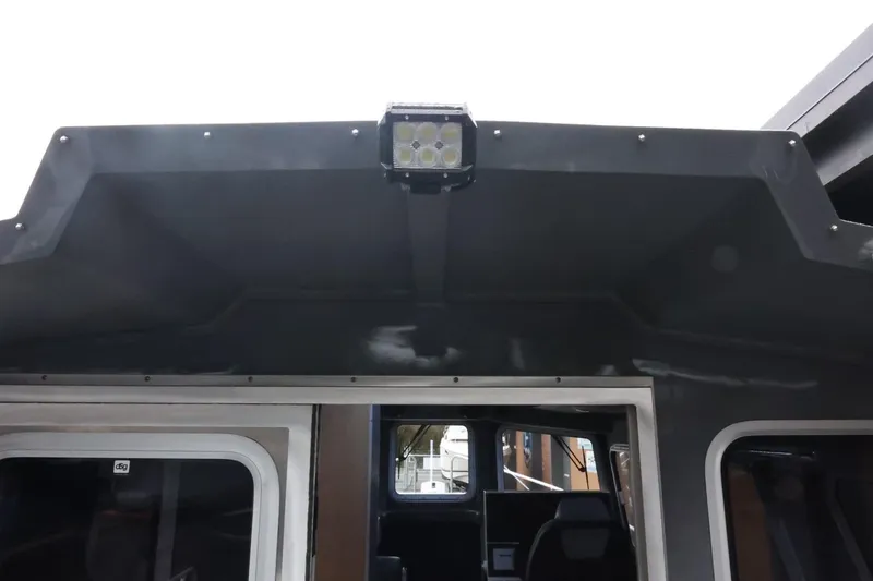 Slide: The Image of 2026 Thunder Jet 28 Pilot boat interior with overhead light detail. - 63