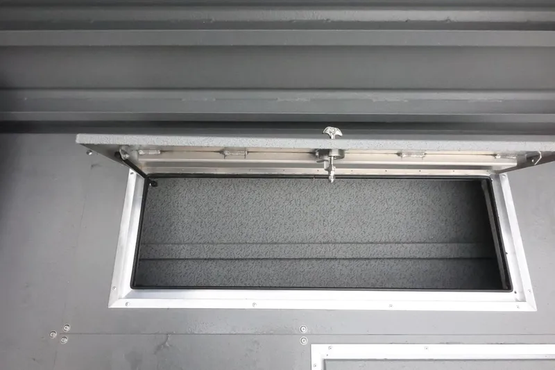 Slide: The Image of Open storage compartment on 2026 Thunder Jet 28 Pilot boat, featuring a secure latch system. - 64