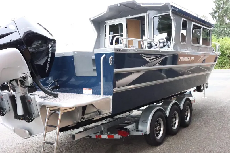 Slide: The Image of 2026 Thunder Jet 28 Pilot boat on trailer, featuring Mercury outboard engine. - 8