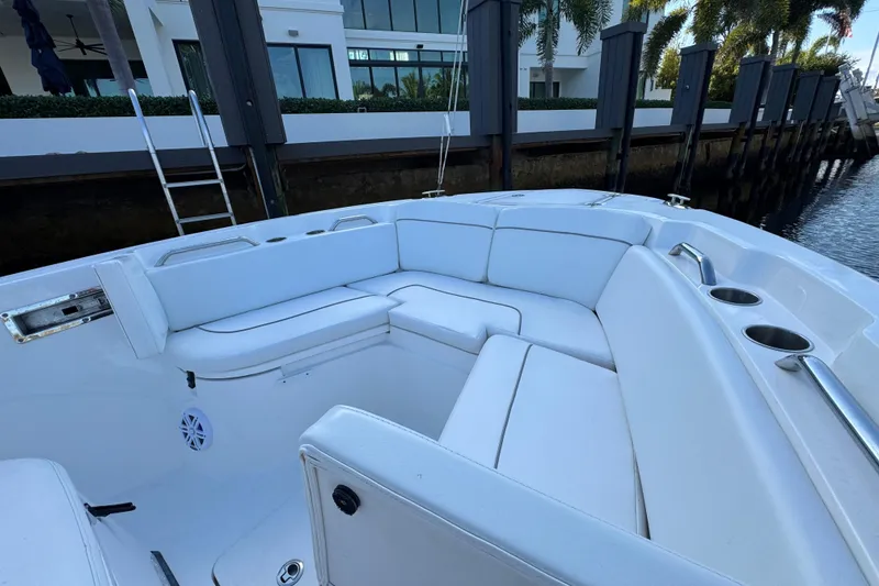 Slide: The Image of 2021 Sea Fox 268 Commander boat with white cushioned seating and cup holders. - 11