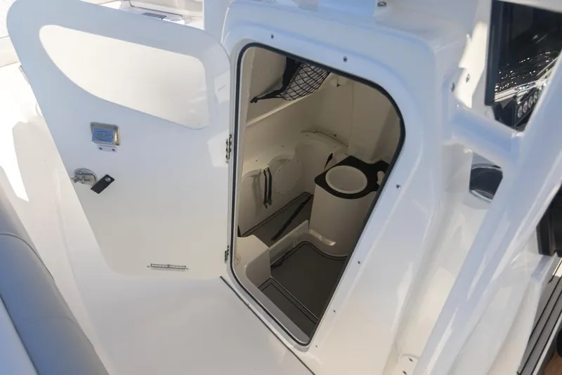 Slide: The Image of Manufacturer Provided Image: 2021 Sea Fox 268 Commander boat interior with open door to compact restroom. - 13