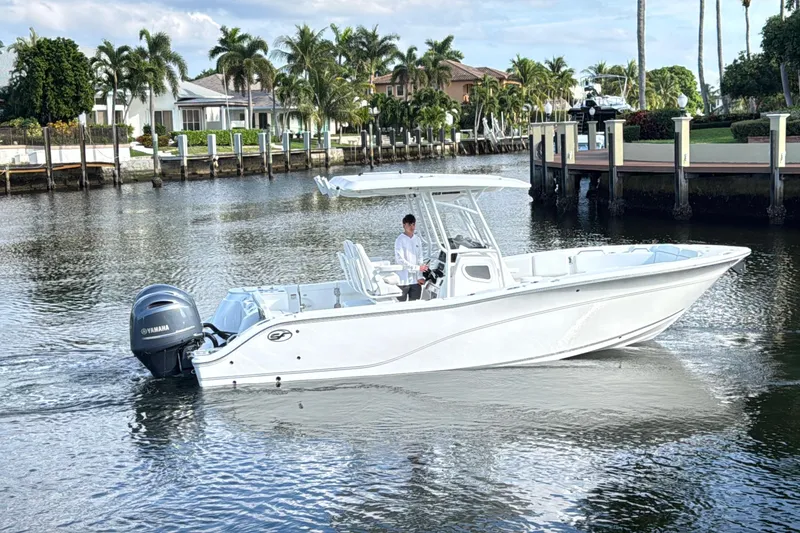 Slide: The Image of 2021 Sea Fox 268 Commander boat cruising near waterfront homes with palm trees. - 2