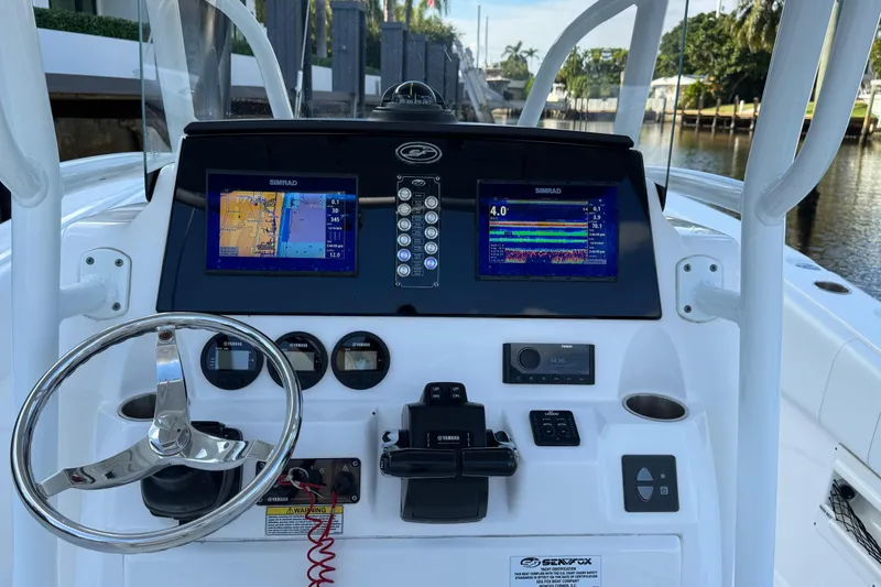 Slide: The Image of 2021 Sea Fox 268 Commander dashboard with Simrad displays and steering wheel. - 22