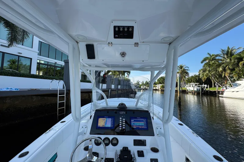 Slide: The Image of 2021 Sea Fox 268 Commander boat interior with navigation screens, docked by a canal. - 23