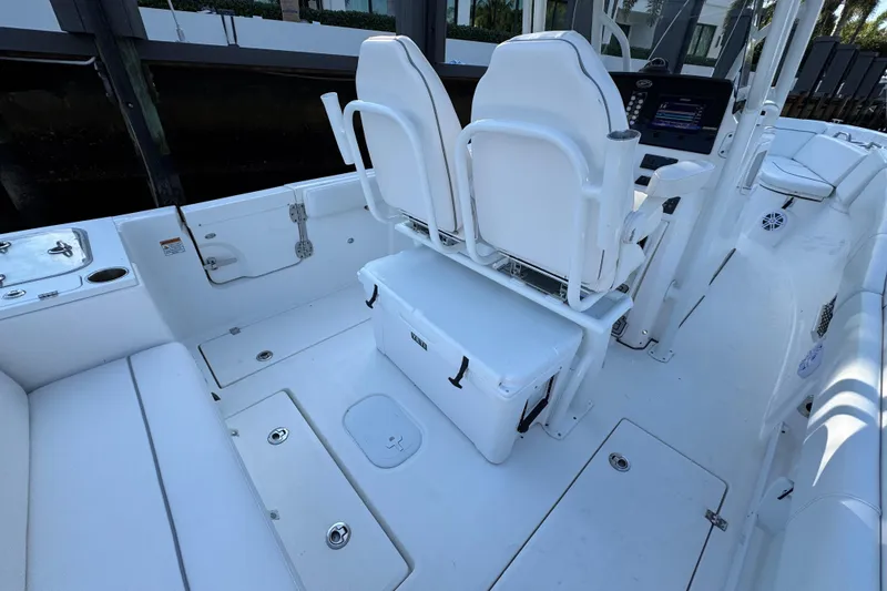 Slide: The Image of 2021 Sea Fox 268 Commander boat interior with white seating and storage compartments. - 25