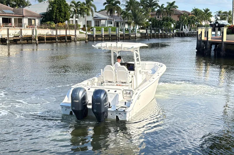 Slide: The Image of 2021 Sea Fox 268 Commander boat navigating a scenic waterfront area. - 3
