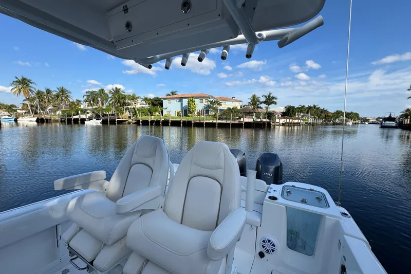 Slide: The Image of 2021 Sea Fox 268 Commander boat interior with luxurious seating, overlooking a scenic waterfront. - 5
