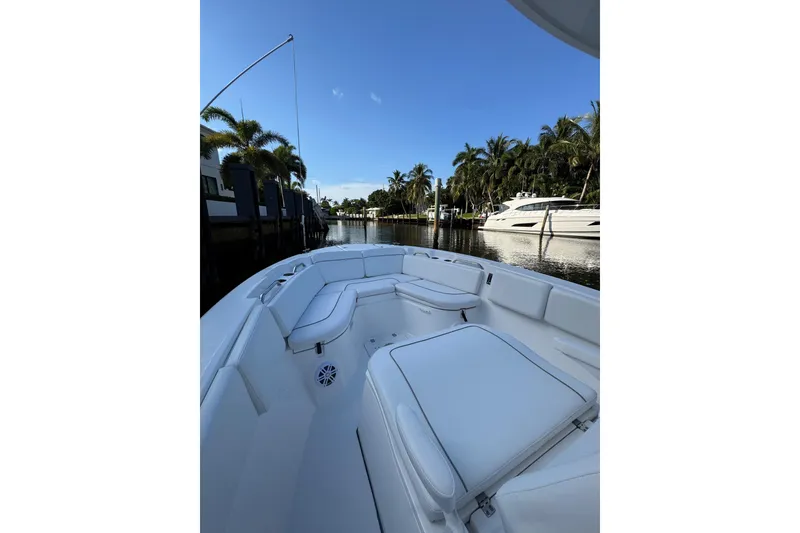 Slide: The Image of 2021 Sea Fox 268 Commander boat with white seating, docked near palm trees. - 7