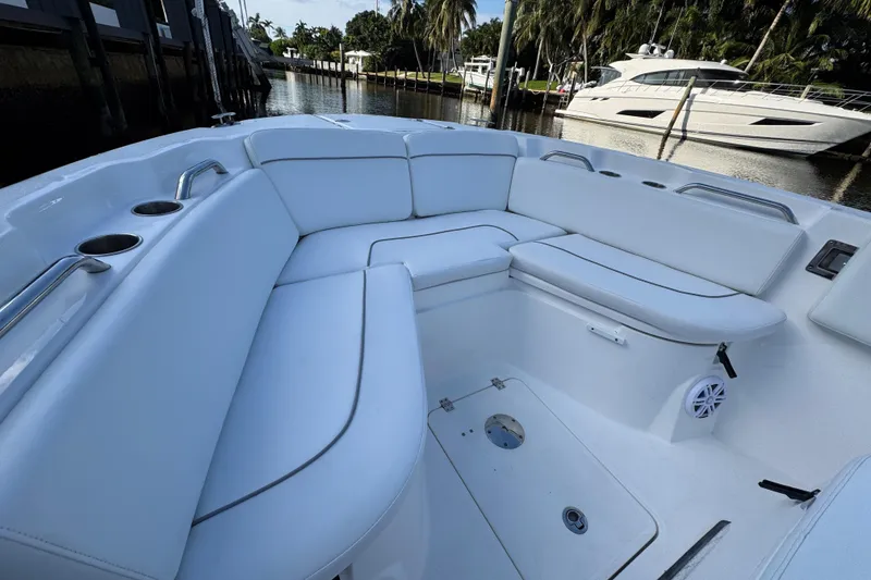 Slide: The Image of 2021 Sea Fox 268 Commander boat interior with white cushioned seating and cup holders. - 8