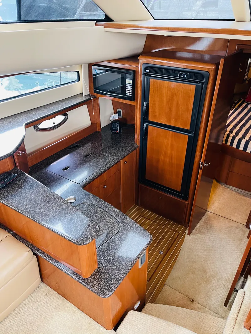 Slide: The Image of Interior of 2006 Meridian 408 Motoryacht featuring kitchen and sleeping area. - 13