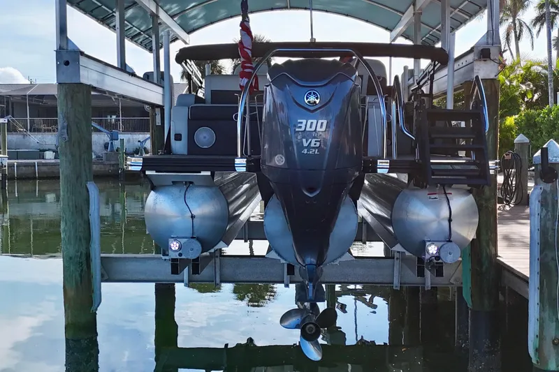 Slide: The Image of 2023 Barletta Corsa 23UC pontoon boat with Yamaha 300 V6 engine at dock. - 2