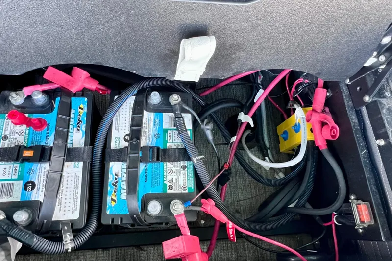Slide: The Image of 2023 Barletta Corsa 23UC boat battery compartment with wiring and connections. - 26