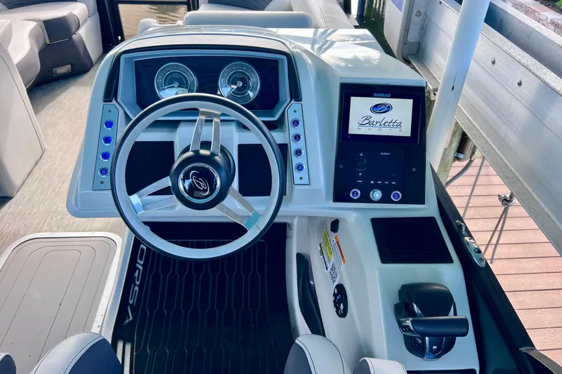 Slide: The Image of 2023 Barletta Corsa 23UC boat dashboard with steering wheel and control panel. - 35
