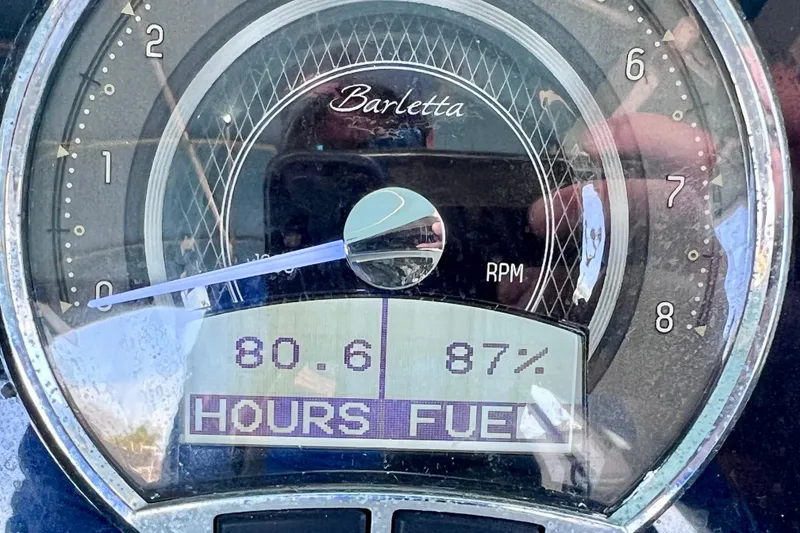 Slide: The Image of Close-up of 2023 Barletta Corsa 23UC dashboard showing RPM, hours, and fuel percentage. - 44