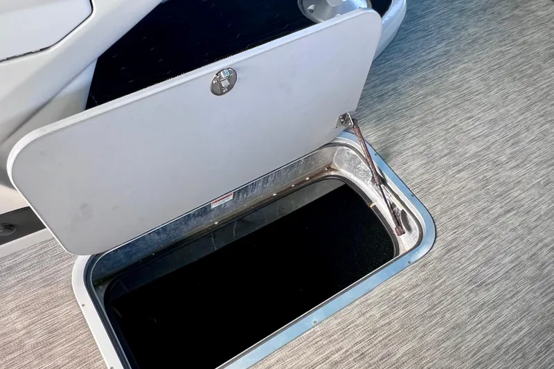Slide: The Image of Open storage compartment on 2023 Barletta Corsa 23UC boat, featuring sleek design. - 47