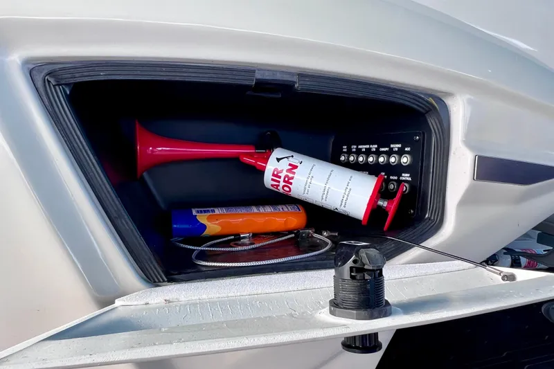 Slide: The Image of Storage compartment of 2023 Barletta Corsa 23UC with air horn and control panel. - 48