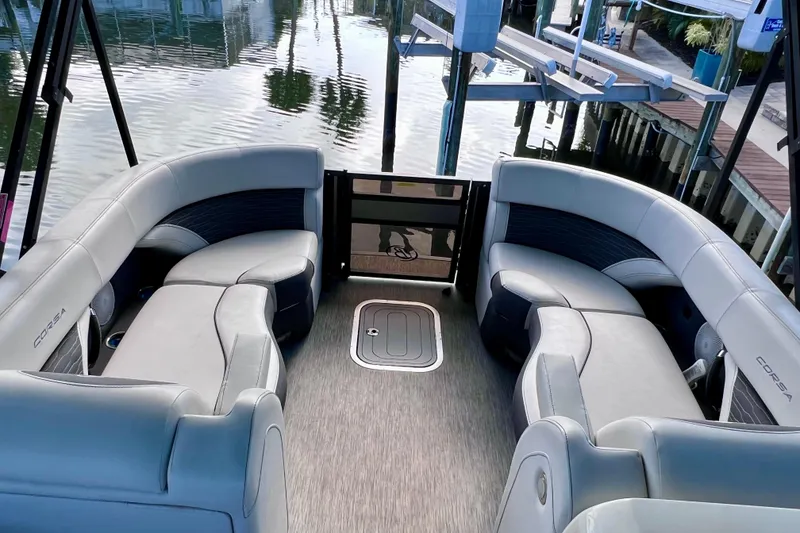 Slide: The Image of 2023 Barletta Corsa 23UC pontoon boat interior with luxurious seating and waterfront view. - 50