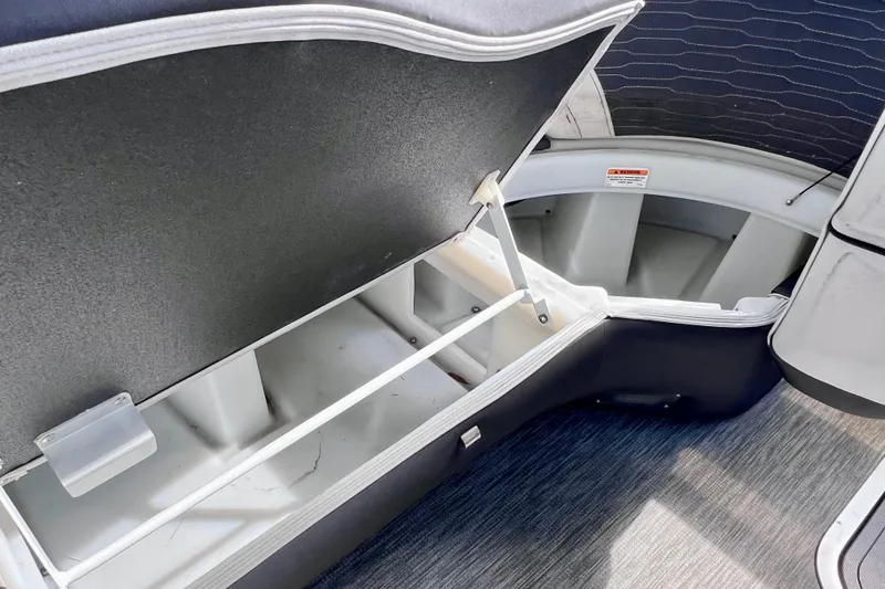 Slide: The Image of 2023 Barletta Corsa 23UC boat storage compartment with open lid, showcasing interior space. - 53