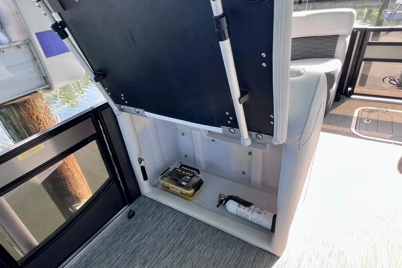 Slide: The Image of 2023 Barletta Corsa 23UC boat storage compartment with safety equipment. - 56