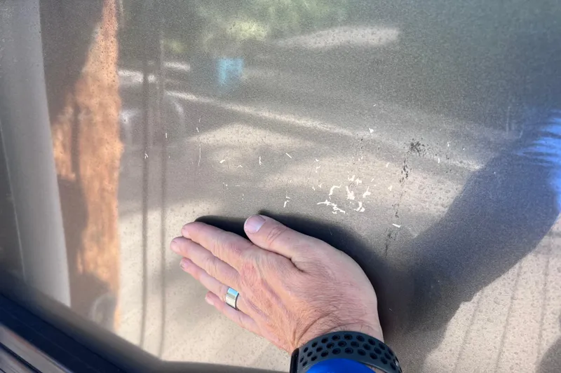 Slide: The Image of Hand inspecting scratches on 2023 Barletta Corsa 23UC exterior surface. - 67