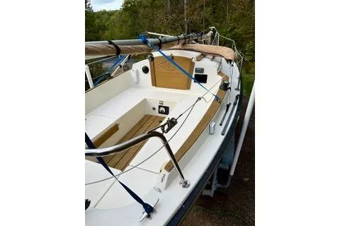 Slide: The Image of 2019 Com-Pac 23/IV sailboat with wooden deck details and rigging, docked outdoors. - 5