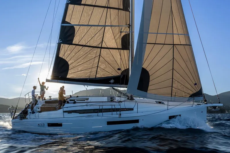 The Image of Manufacturer Provided Image: 2025 Jeanneau Sun Odyssey 415 sailing on open water at sunset. - 0