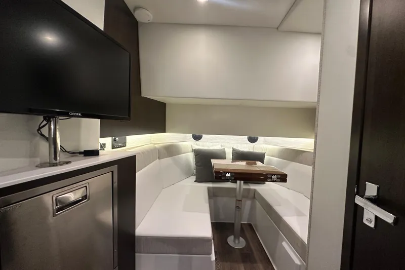 Slide: The Image of 2024 Cruisers Yachts 38 GLS OB interior with cozy seating and modern amenities. - 13