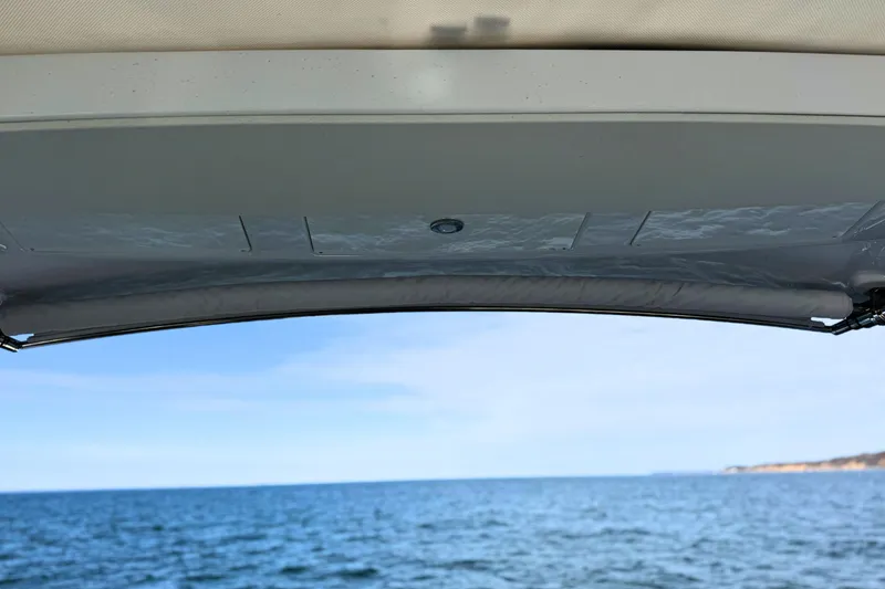 Slide: The Image of 2024 Cruisers Yachts 38 GLS OB, ocean view from under the boat's canopy. - 25