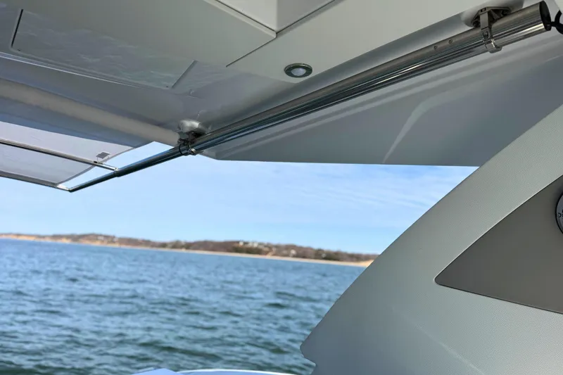 Slide: The Image of 2024 Cruisers Yachts 38 GLS OB, view of retractable awning over water. - 28