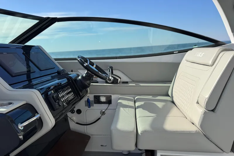 Slide: The Image of 2024 Cruisers Yachts 38 GLS OB helm with modern controls and comfortable seating. - 33