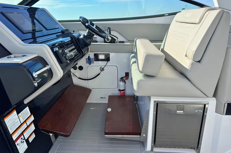 Slide: The Image of 2024 Cruisers Yachts 38 GLS OB helm with modern controls and seating. - 34