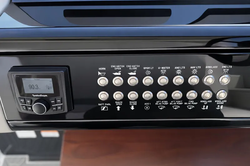 Slide: The Image of Control panel of 2024 Cruisers Yachts 38 GLS OB with radio and various switches. - 38