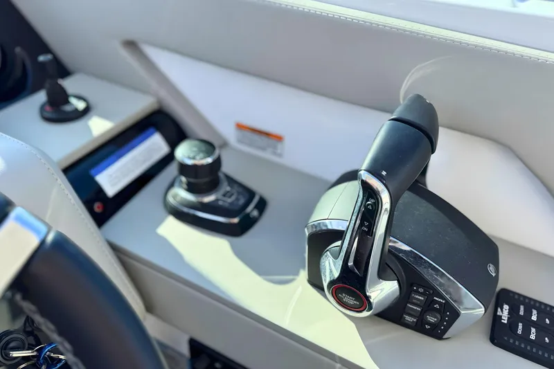 Slide: The Image of 2024 Cruisers Yachts 38 GLS OB helm controls with joystick and throttle. - 39